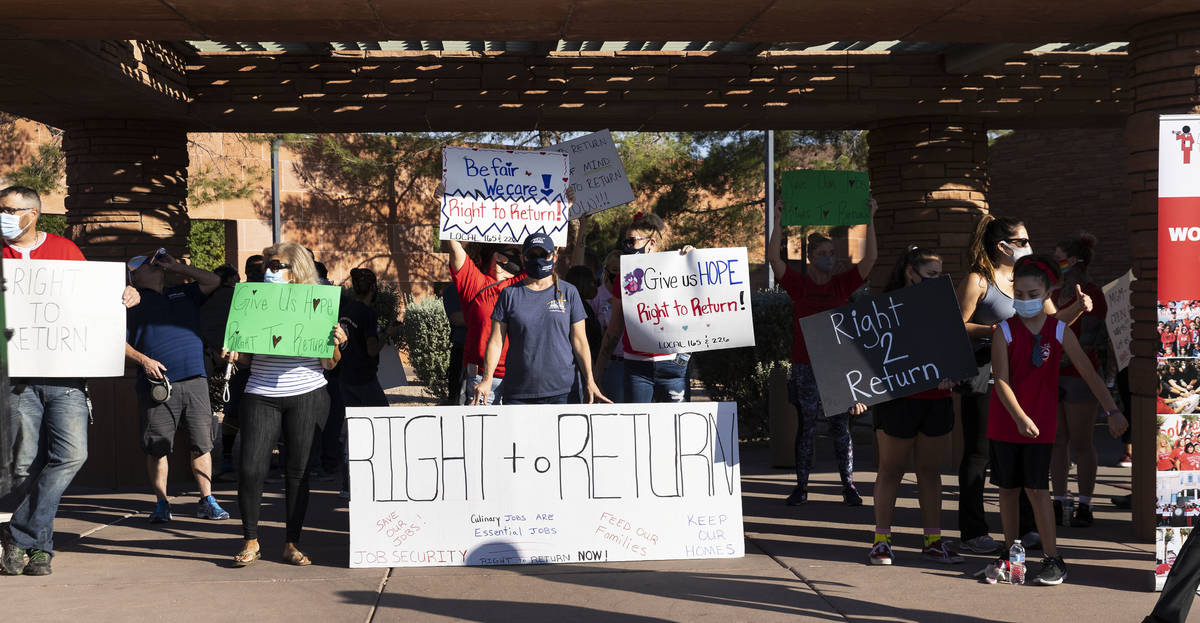 Workers, including Reina Almuina, second left, a waitress at Aria, and Renee Fountain, center, ...