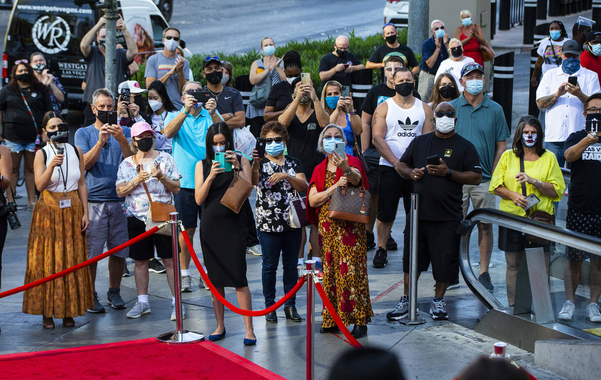 People watch as dancers perform to mark the reopening of the Planet Hollywood Resort in Las Veg ...