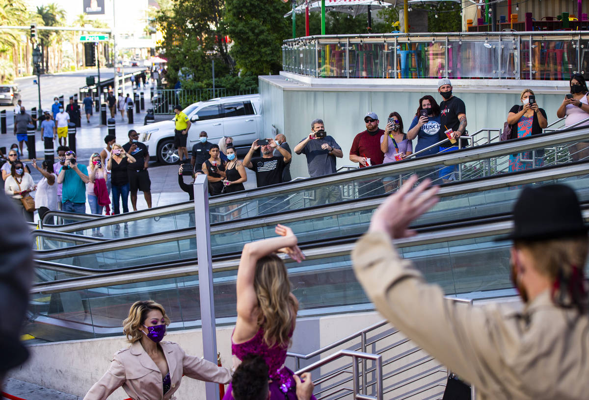 People watch as dancers perform to mark the reopening of the Planet Hollywood Resort in Las Veg ...