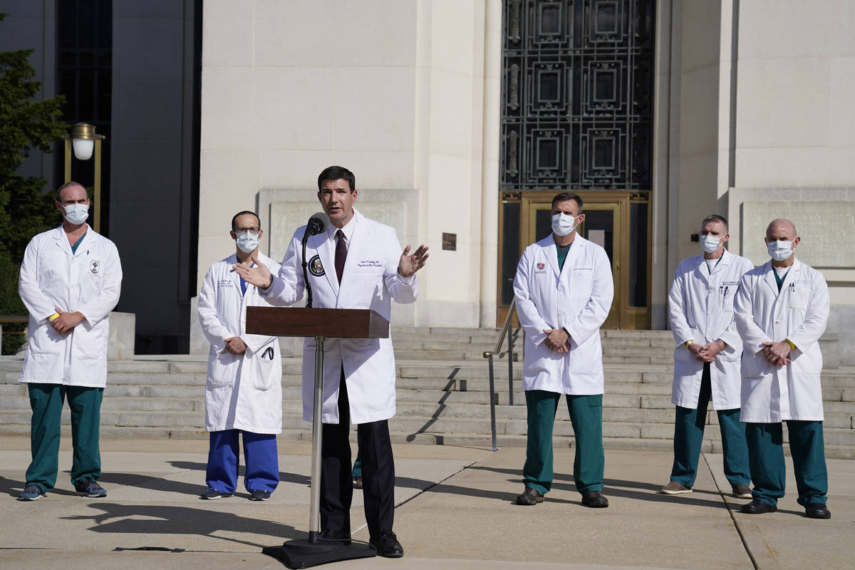 Dr. Sean Conley, physician to President Donald Trump, center, talks with reporters at Walter Re ...