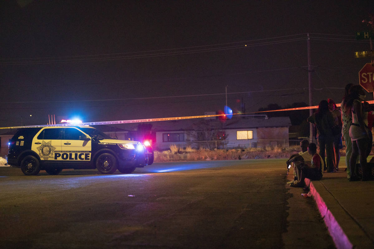 People gather during an investigation after the discovery of a dead 22-month-old child was foun ...