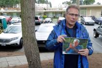 In this March 12, 2020, file photo, Scott Sedlacek poses while holding a photo of his father, C ...