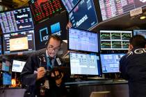 In this March 16, 2020, file photo, trader Gregory Rowe works on the floor of the New York Stoc ...