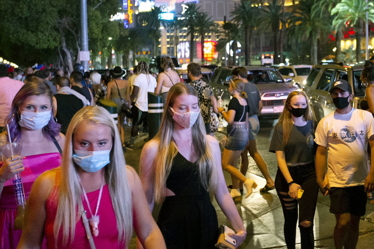 A crowd crosses Bellagio Drive during Labor Day weekend on Saturday, Sept. 5, 2020, on the Las ...