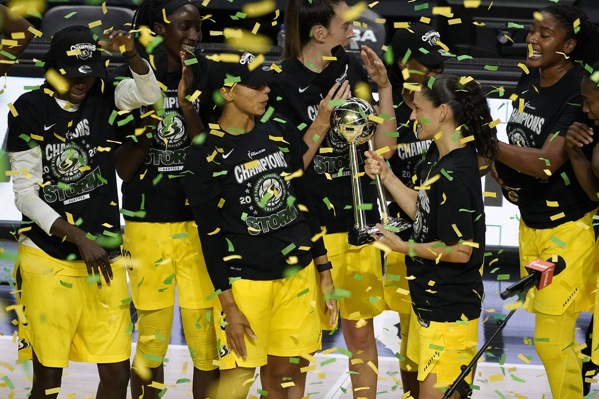 Seattle Storm guard Sue Bird shows the trophy to some of her teammates after the team defeated ...