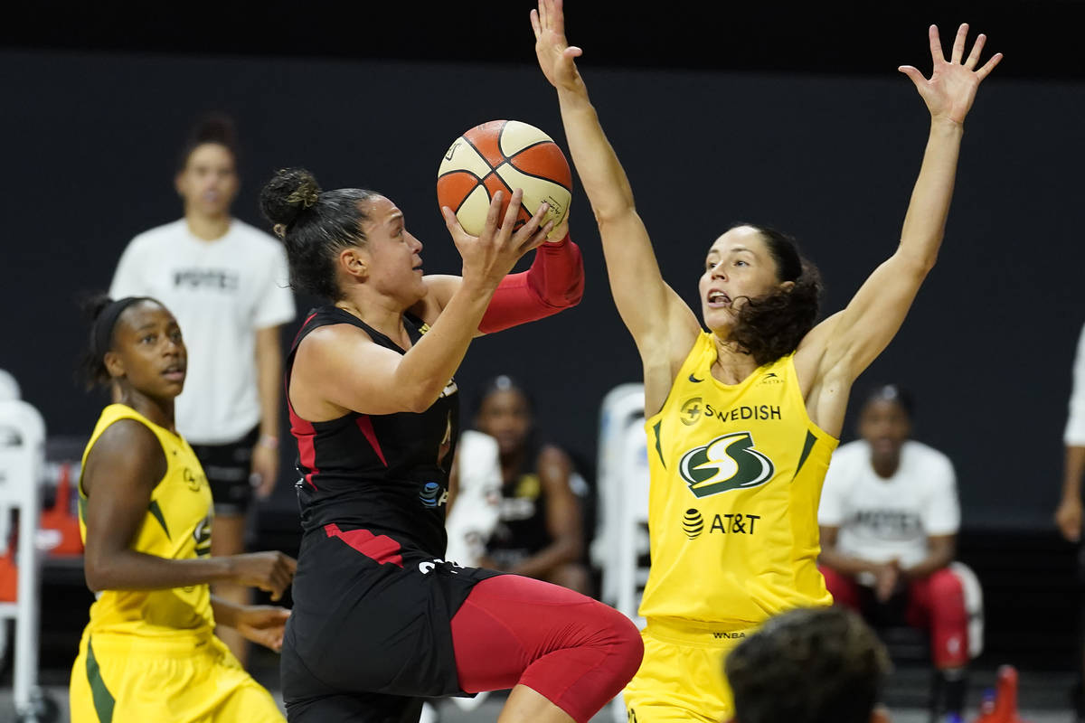 Las Vegas Aces guard Kayla McBride (21) shoots over Seattle Storm guard Jewell Loyd (24) and gu ...