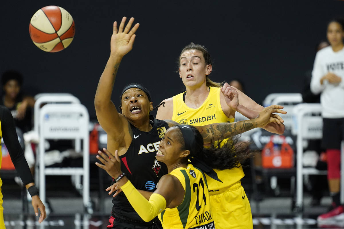 Las Vegas Aces forward Emma Cannon (32), Seattle Storm guard Jordin Canada (21) and Storm forwa ...