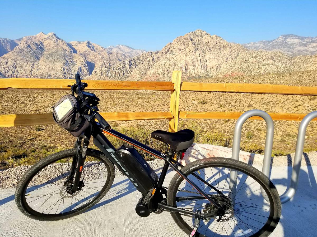 Rented e-bike with bulky-but-miraculous battery attached to the frame is parked at the scenic d ...