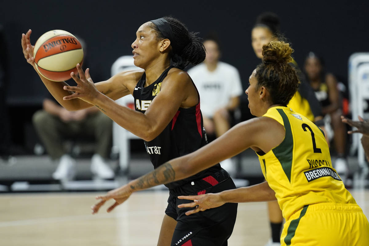 Las Vegas Aces center A'ja Wilson (22) grabs a pass while being guarded by Seattle Storm center ...