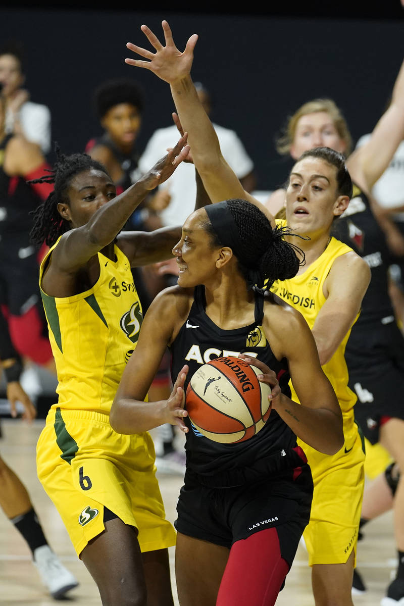 Las Vegas Aces center A'ja Wilson (22) is blocked by Seattle Storm forward Natasha Howard (6) a ...