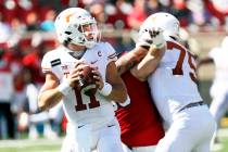 In this Saturday Sept. 26, 2020, file photo, Texas quarterback Sam Ehlinger looks for an open r ...