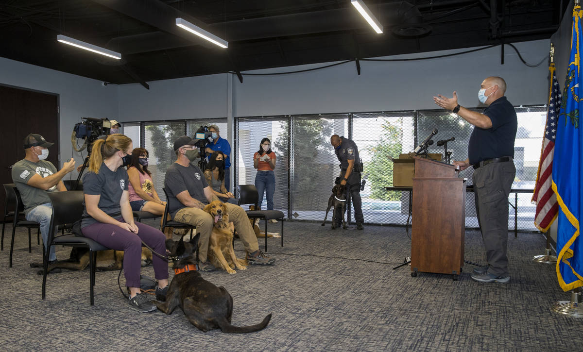Trainer Cameron Ford with Ford K-9, right, conducts a graduation ceremony for Nevada Highway Pa ...