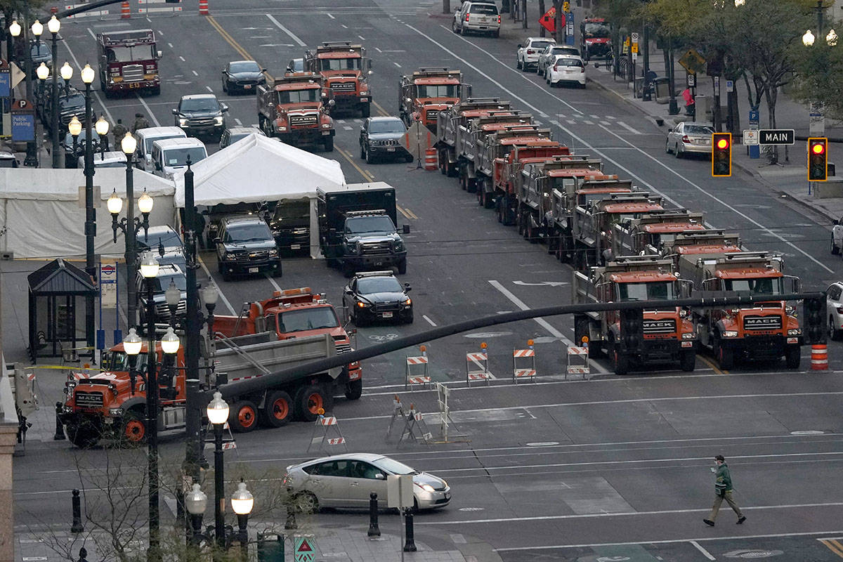 A perimeter is set by heavy dump trucks around a hotel in downtown Salt Lake City, the site of ...