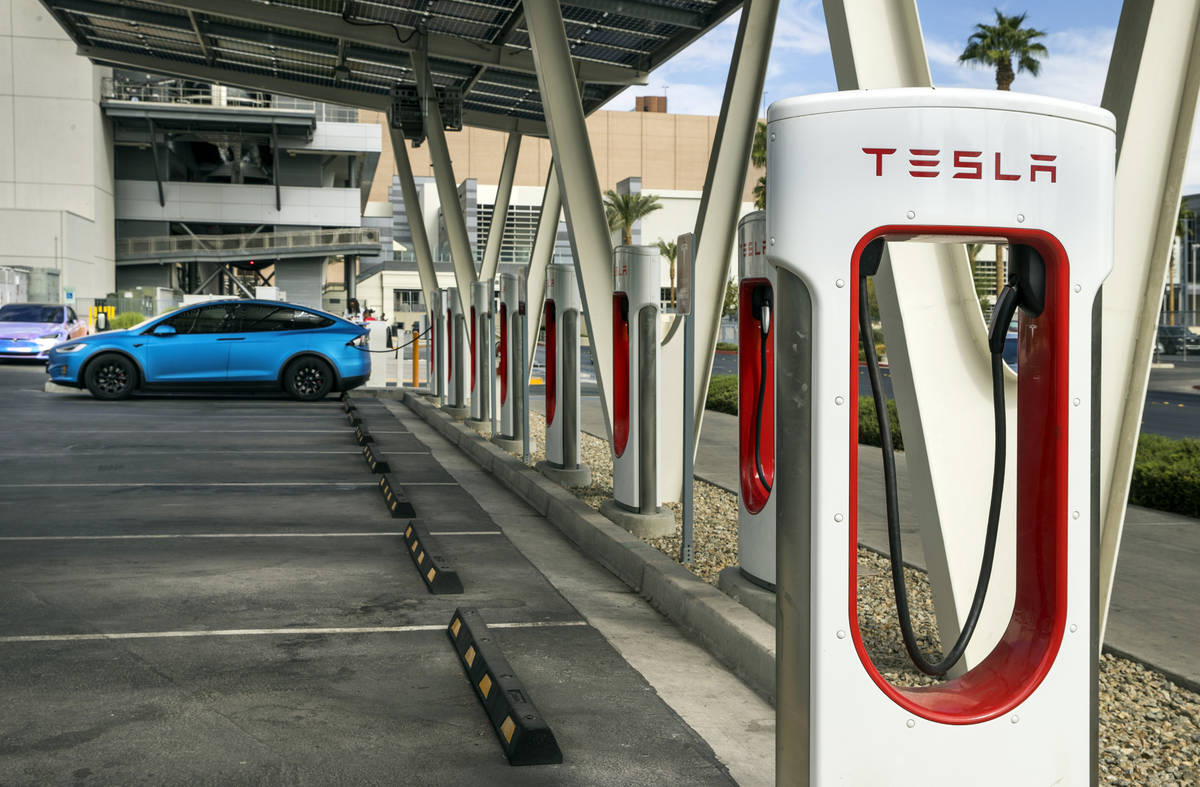 A car is plugged in at the Tesla Supercharger station near The Linq and High Roller on Friday, ...