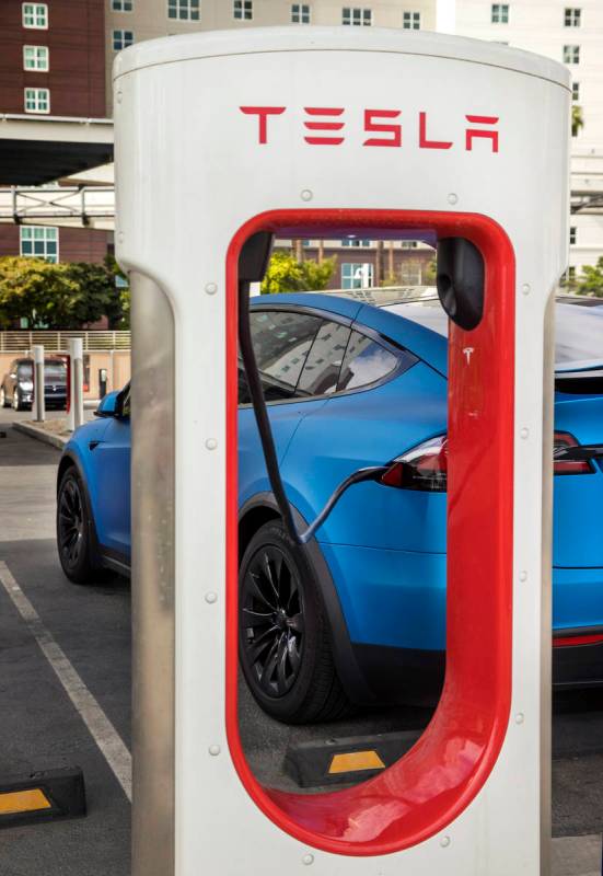 A car is plugged in at the Tesla Supercharger station near The Linq and High Roller on Friday, ...