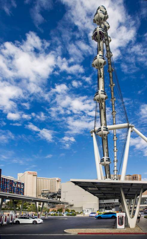 Several cars plug in at the Tesla Supercharger station near The Linq and High Roller on Friday, ...