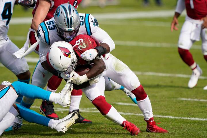Arizona Cardinals running back Chase Edmonds is tackled by Carolina Panthers defensive end Bria ...
