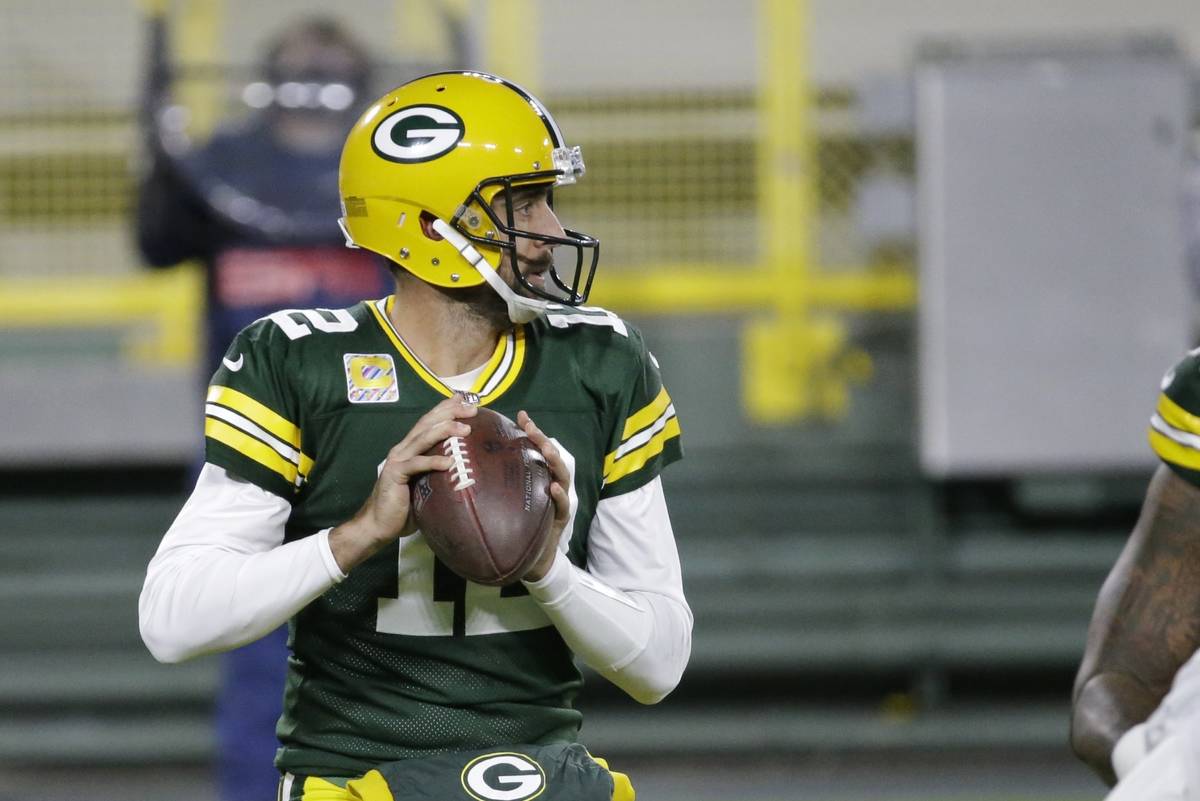 Green Bay Packers quarterback Aaron Rodgers (12) throws during the first half of an NFL footbal ...