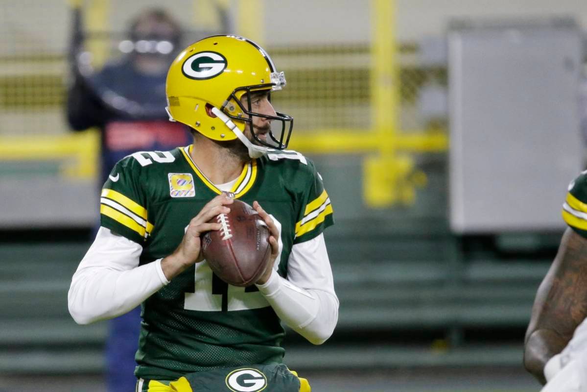 Green Bay Packers quarterback Aaron Rodgers (12) throws during the first half of an NFL footbal ...