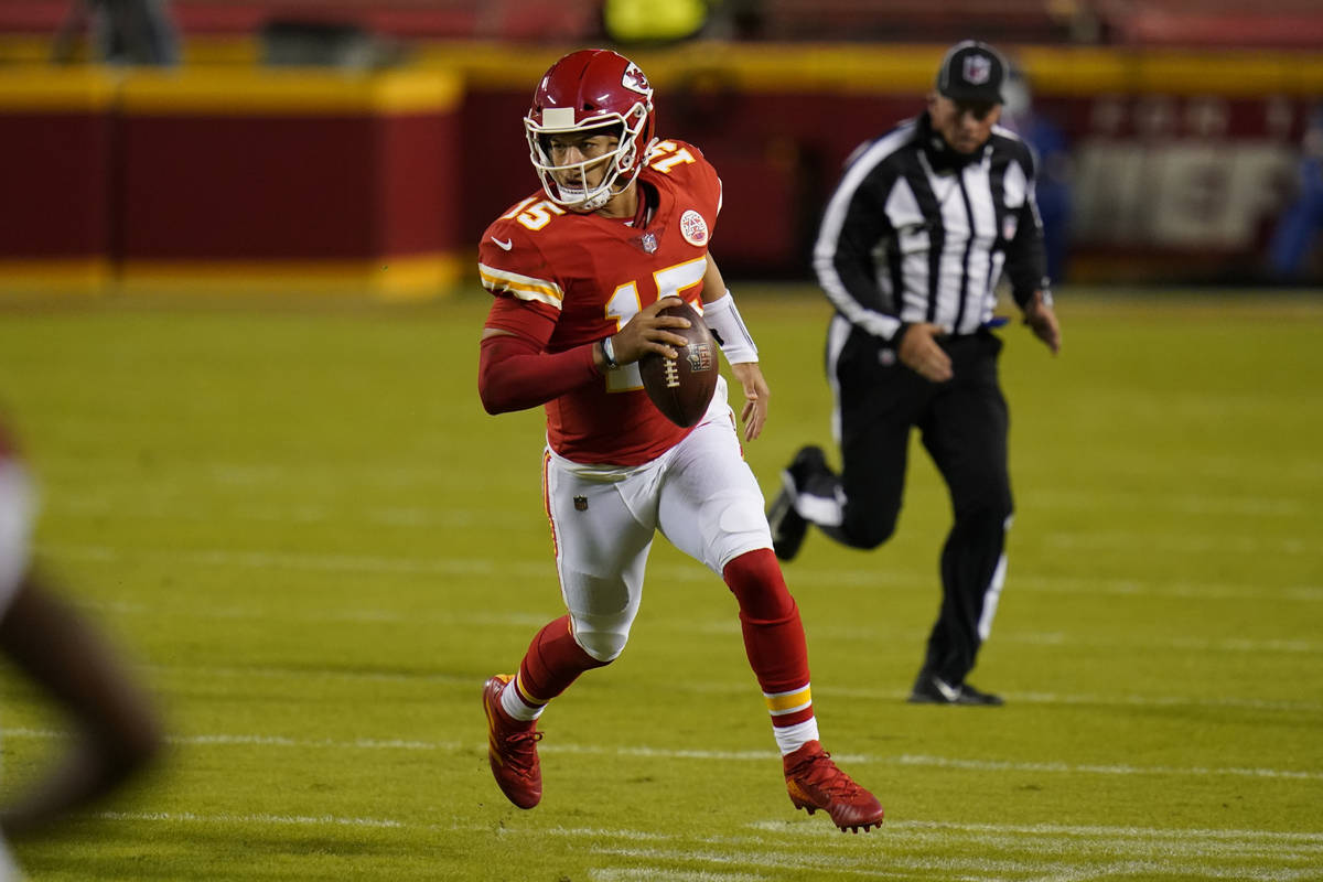 Kansas City Chiefs quarterback Patrick Mahomes (15) runs against the New England Patriots durin ...