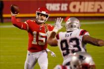 Kansas City Chiefs quarterback Patrick Mahomes (15) throws as New England Patriots defensive ta ...