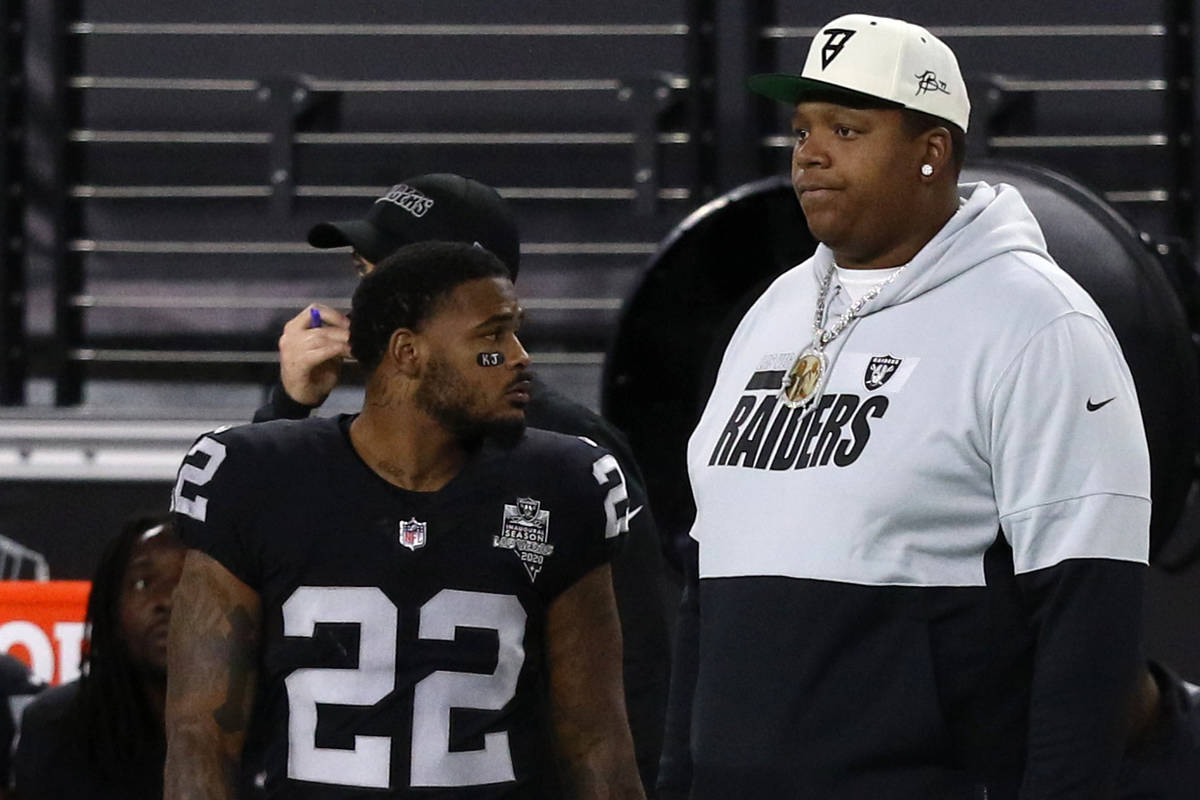 Las Vegas Raiders offensive tackle Trent Brown and cornerback Keisean Nixon (22) watch the game ...