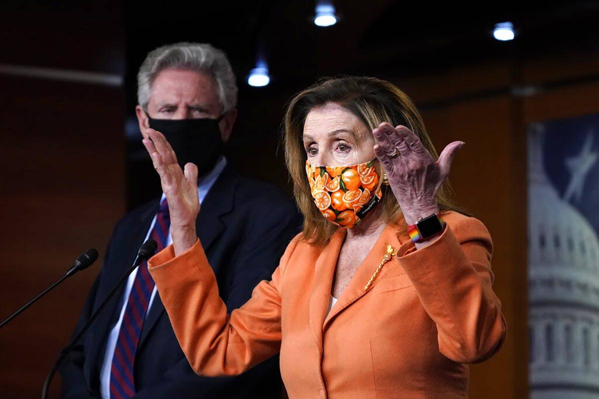 Rep. Frank Pallone, D-N.J., left, listens as Speaker of the House Nancy Pelosi, D-Calif., speak ...