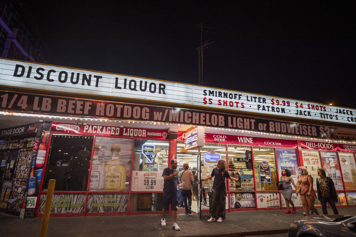 Individuals are seen coming and going from Stage Door CasinoÕs Discount Liquors near the L ...