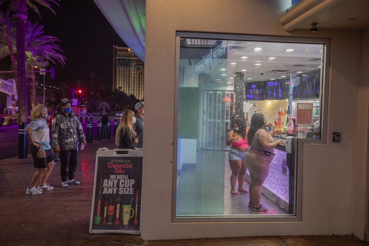 Tourists are seen purchasing drinks from Breeze Daiquiri Bar attached to HarrahÕs on the L ...