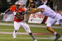 UNLV Rebels running back Charles Williams (8) looks to break a tackle attempt by Southern Utah ...