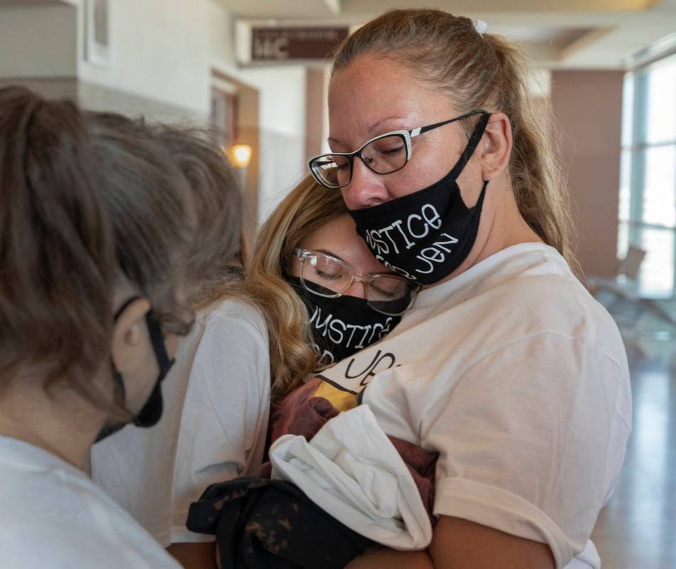 Victim Jennifer Ratay’s daughter, Kelsi Jackson, 16, center, is comforted by family friends C ...