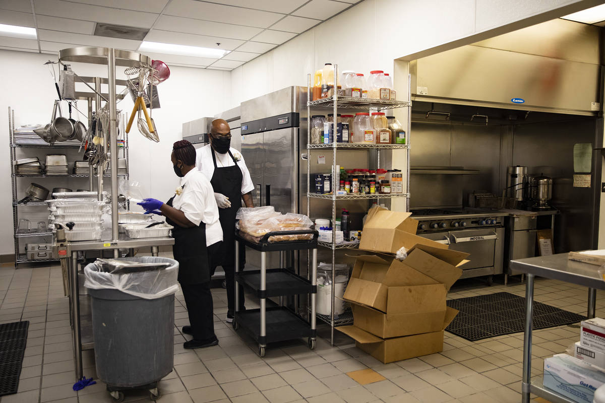 Archy Jett, left, and Lester Johnson, right, work in the expanded kitchen at the newly renovate ...