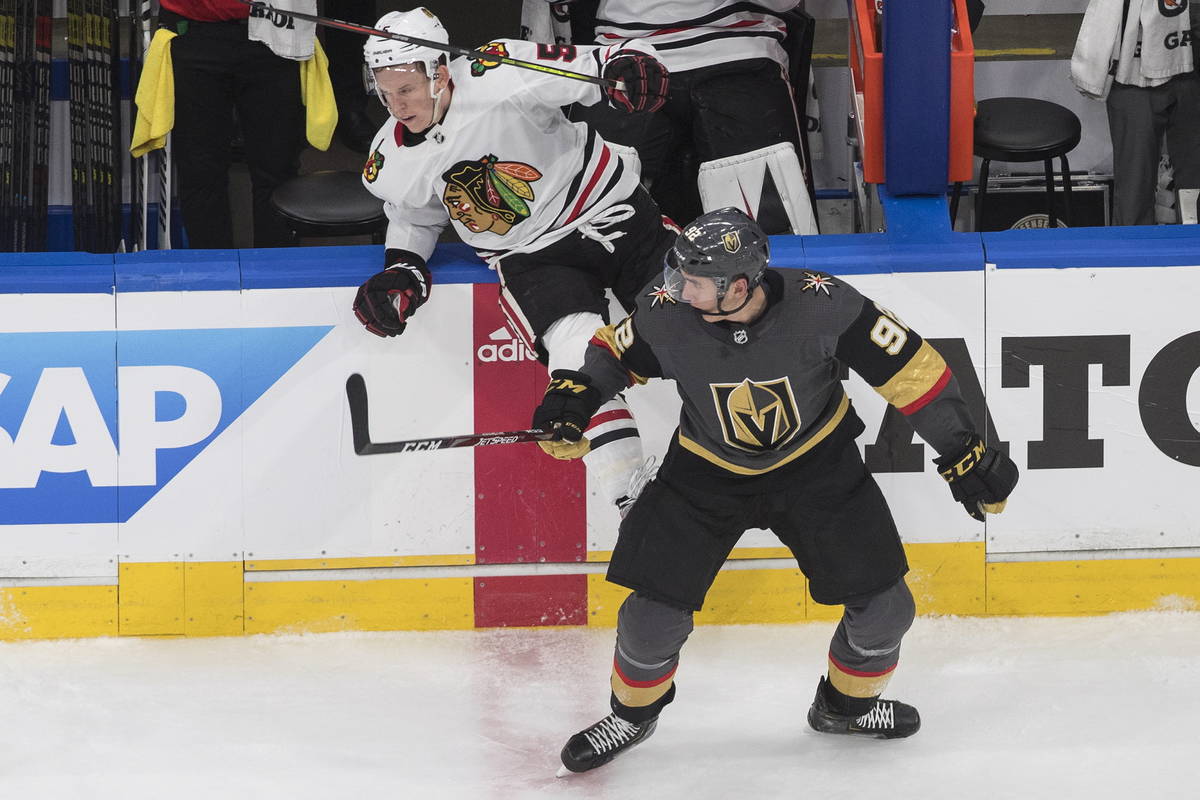 Vegas Golden Knights' Tomas Nosek (92) checks Chicago Blackhawks' Connor Murphy (5) during the ...
