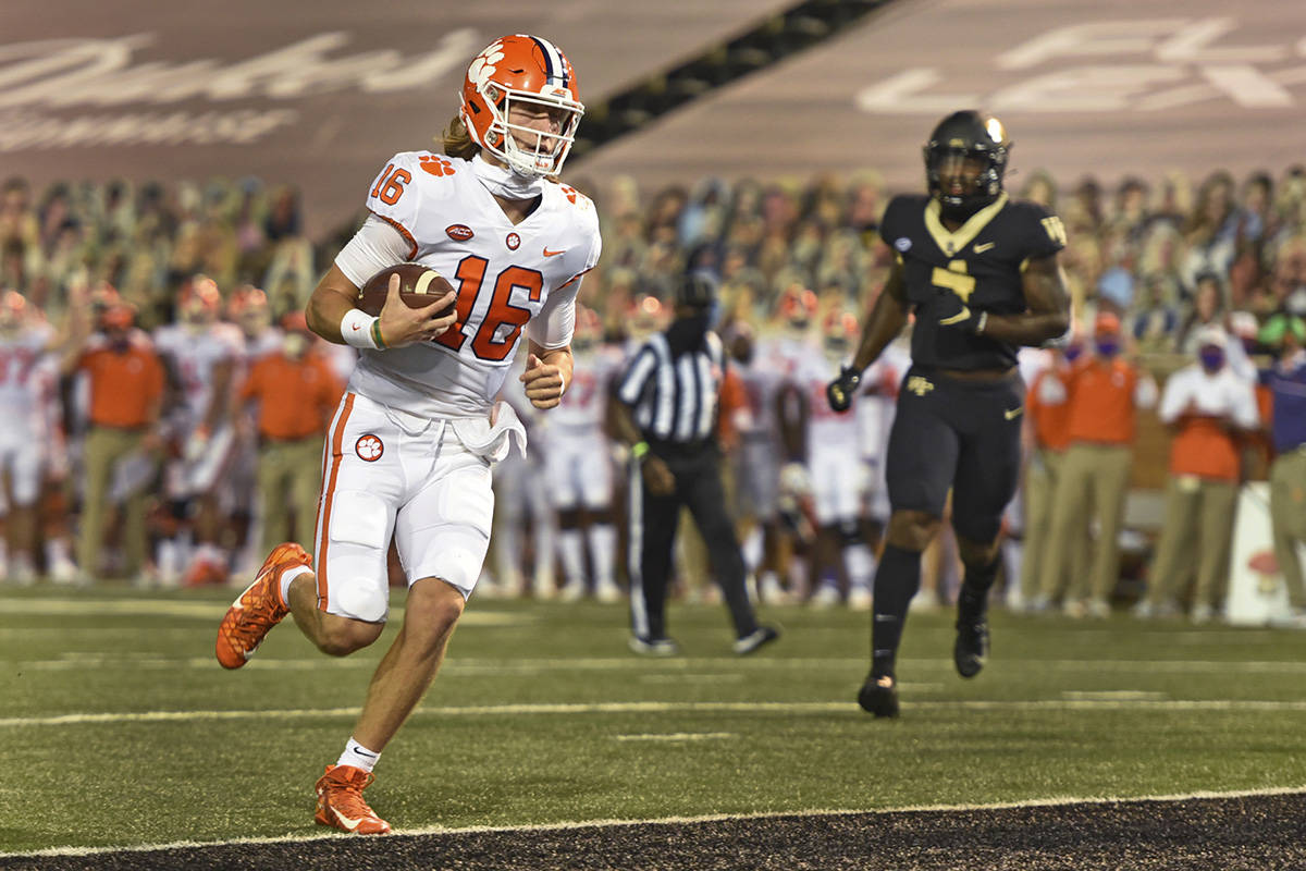 FILE - In this Sept., 12, 2020, file photo, Clemson quarterback Trevor Lawrence scores against ...