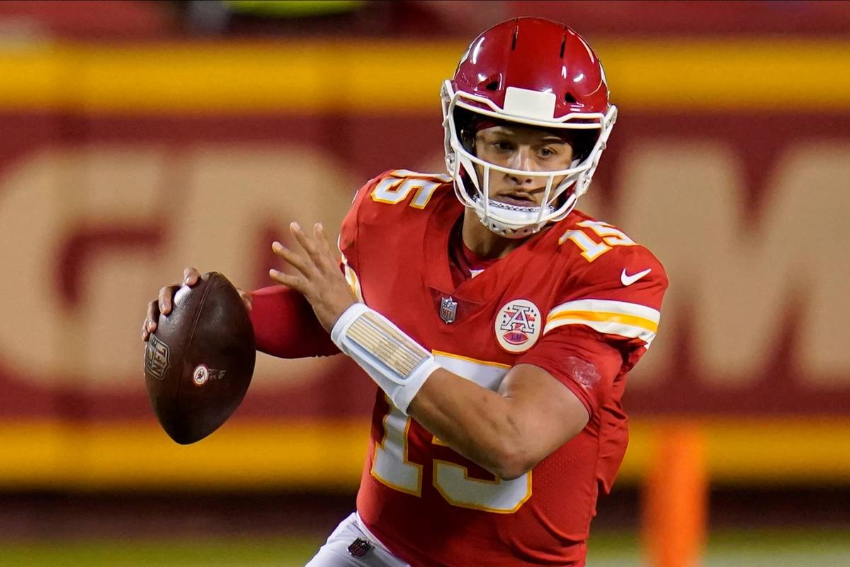 Kansas City Chiefs quarterback Patrick Mahomes (15) runs against the New England Patriots durin ...