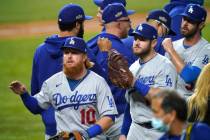 Los Angeles Dodgers' Justin Turner (10) and his teammates celebrate after defeating the San Die ...