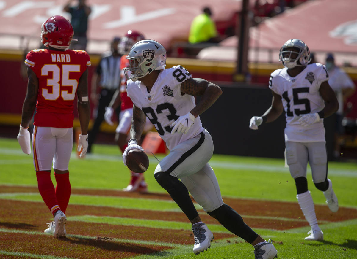 Las Vegas Raiders tight end Darren Waller (83) scores a touchdown as defender Kansas City Chief ...