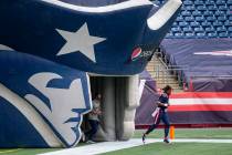 New England Patriots quarterback Cam Newton (1) runs out of the tunnel before an NFL football g ...