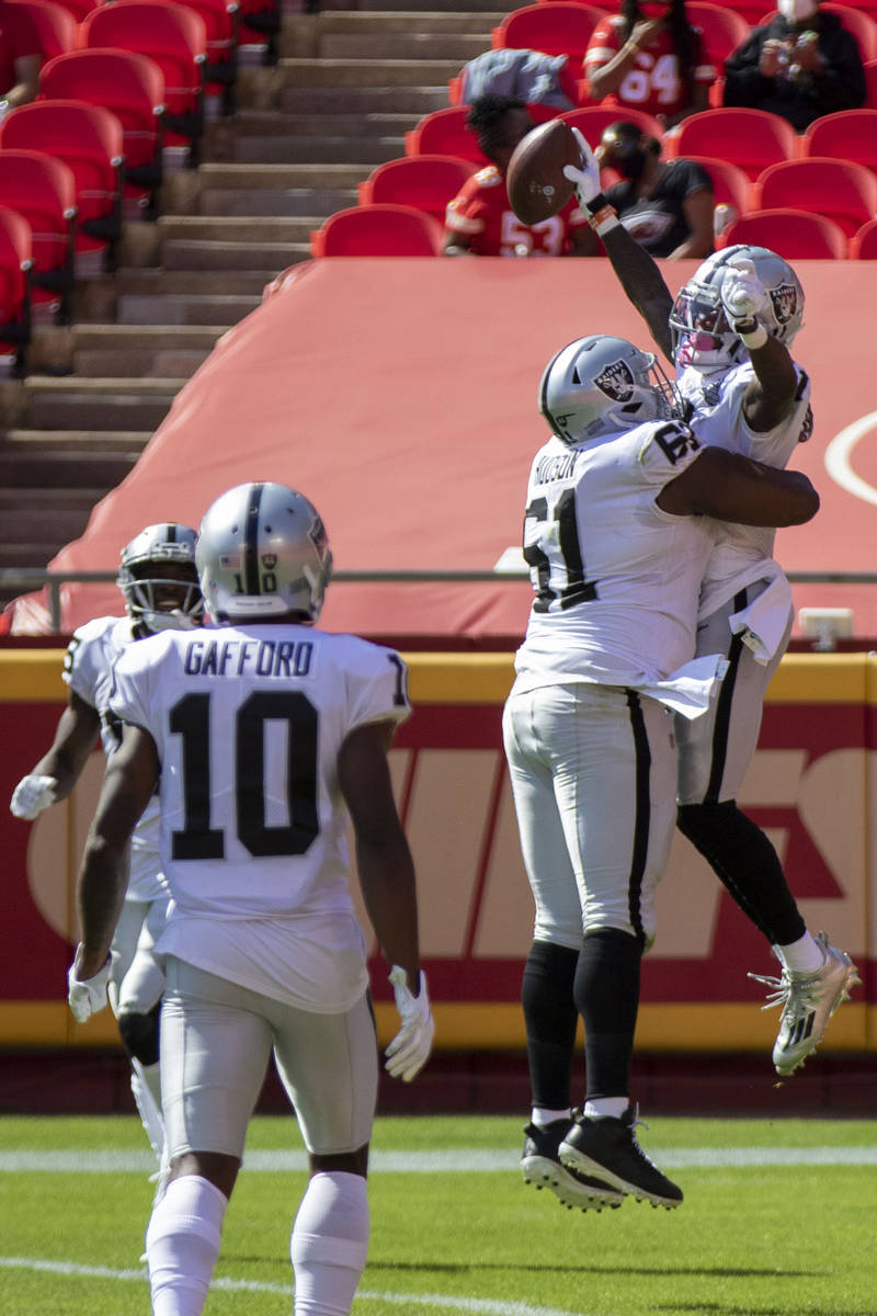 Las Vegas Raiders wide receiver Henry Ruggs III (11) celebrates his touchdown score with center ...