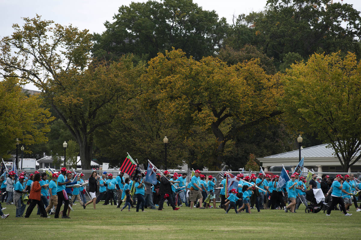 President Donald Trump supporters walk to the gate of the White House after a rally at The Elli ...