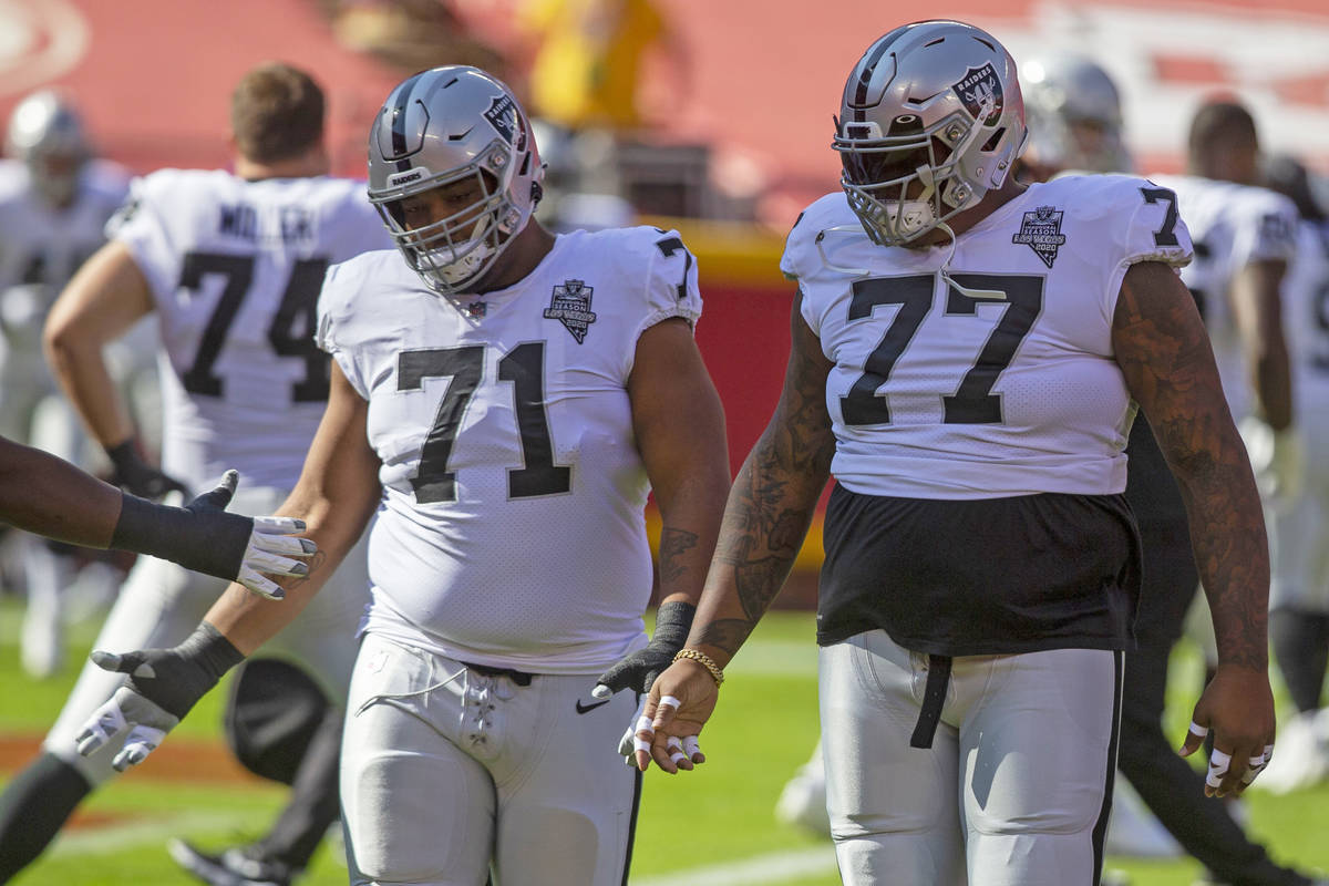 Las Vegas Raiders offensive tackle Denzelle Good (71) and Las Vegas Raiders offensive tackle Tr ...