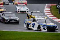 Chase Elliott (9) leads the way out of Turn 7 in a NASCAR Cup Series auto race at Charlotte Mot ...
