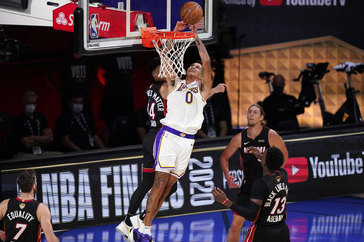 Los Angeles Lakers' Kyle Kuzma (0) takes a shot against Miami Heat's Tyler Herro (14) during th ...