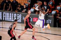 Los Angeles Lakers' LeBron James (23) takes a shot over Miami Heat's Kelly Olynyk (9) during th ...