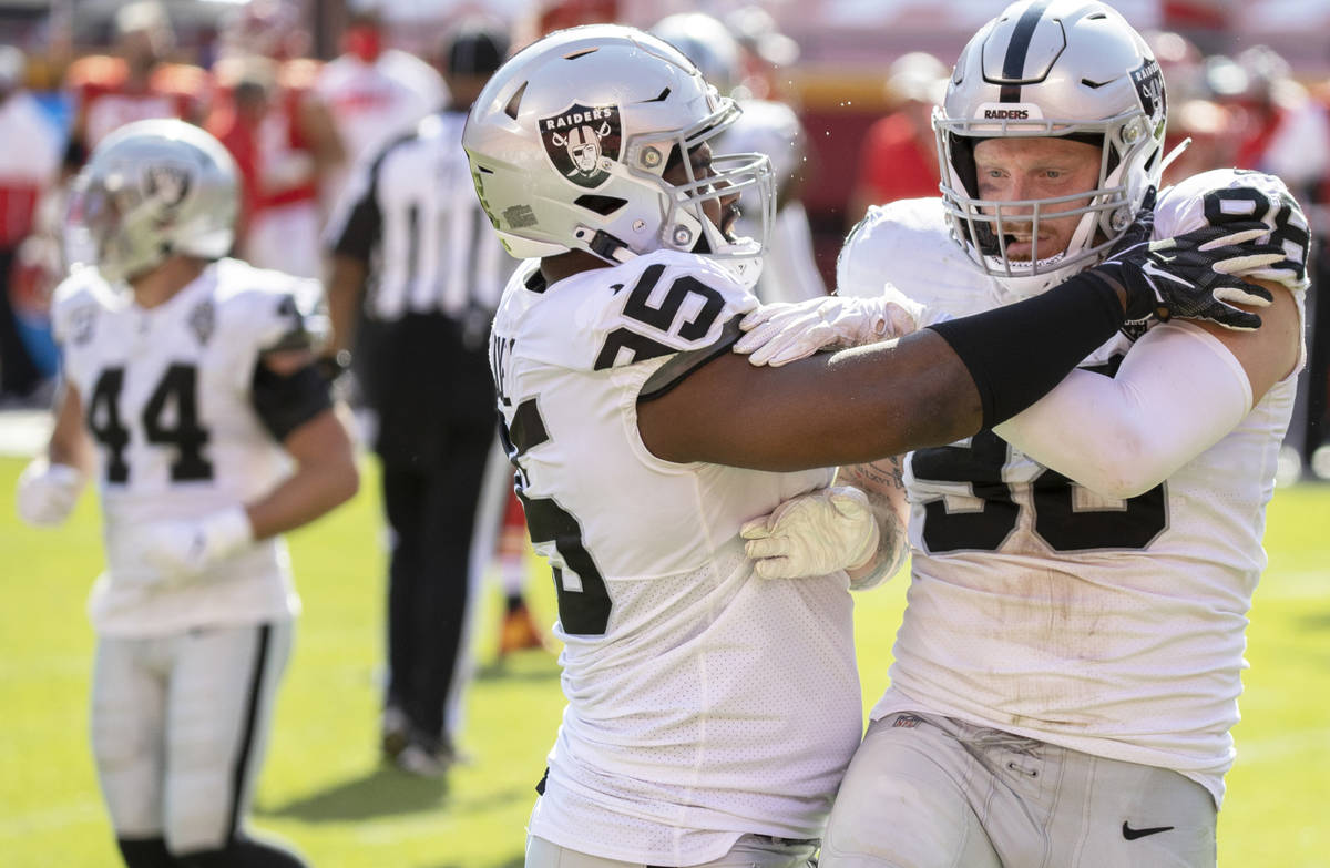 Las Vegas Raiders defensive end Maxx Crosby (98) celebrates with Las Vegas Raiders defensive en ...