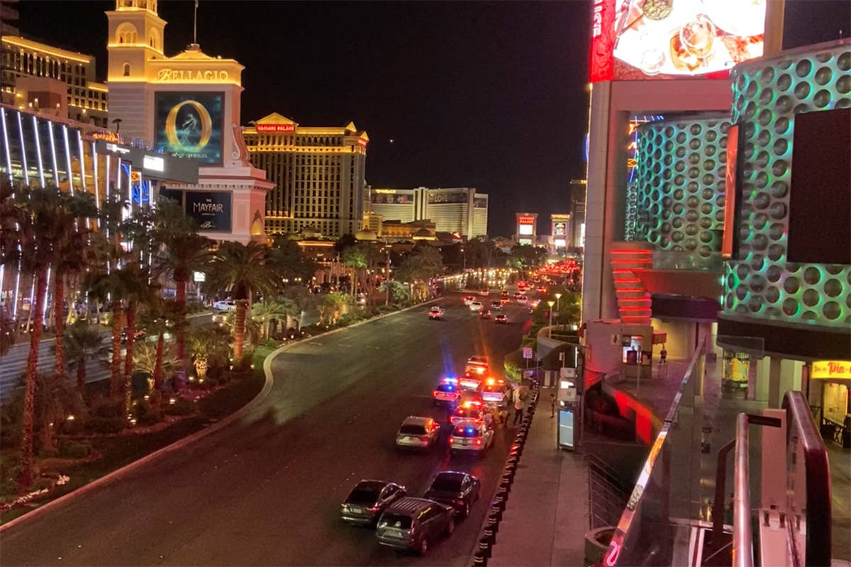 Police investigate a shooting outside the Miracle Mile Shops on the Las Vegas Strip on Sunday, ...