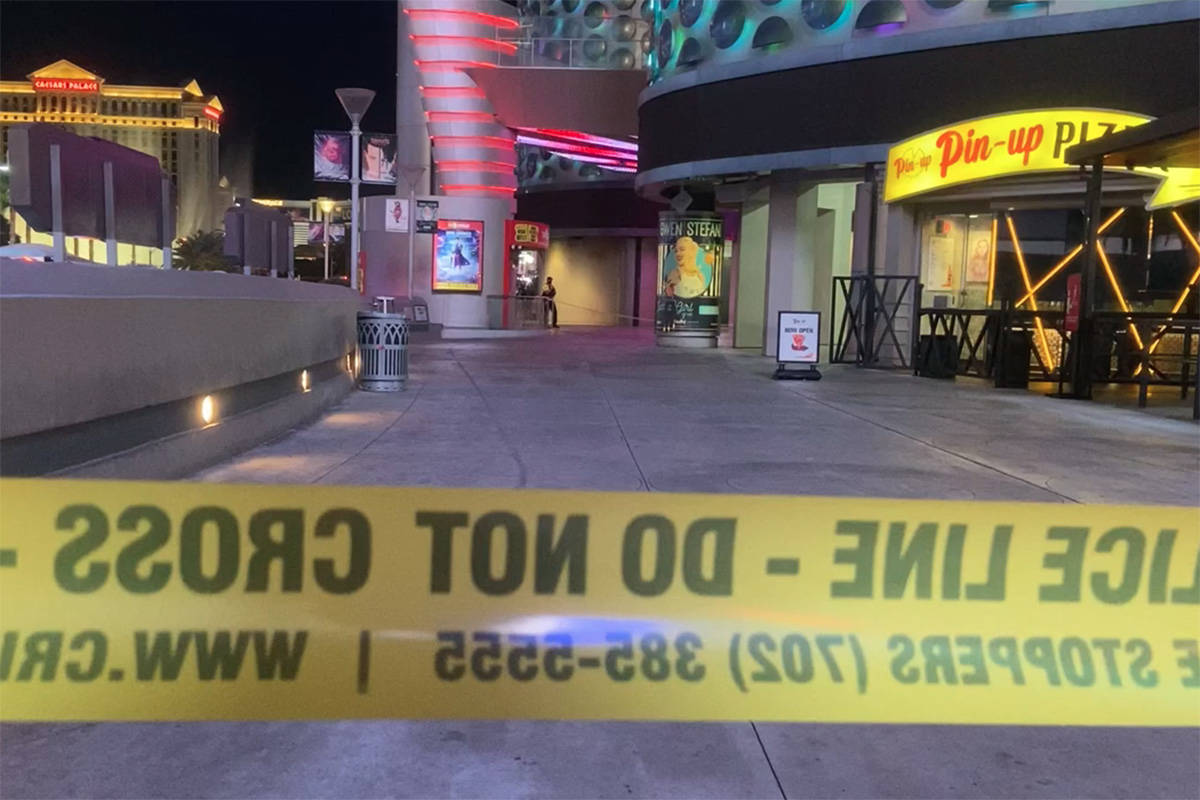 Police investigate a shooting outside the Miracle Mile Shops on the Las Vegas Strip on Sunday, ...