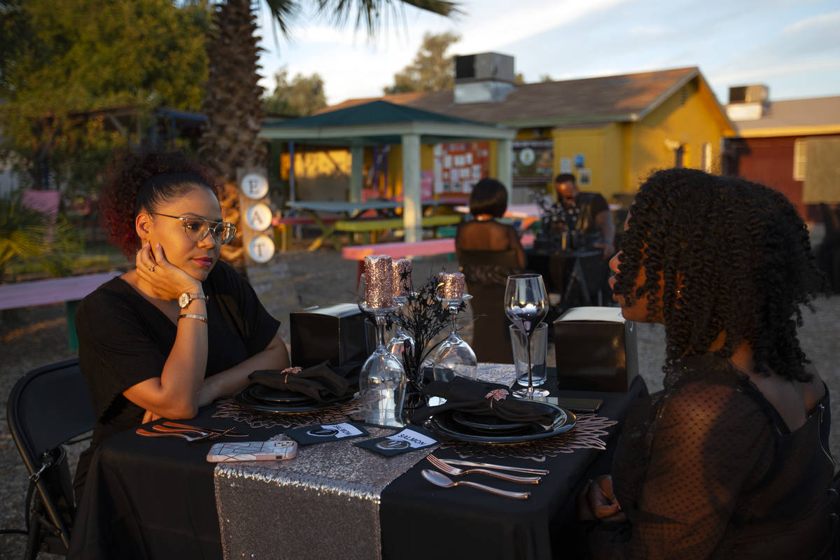 Krystal Derby listens as Najla Grant speaks before dinner at a Noir Culinary Experience event t ...