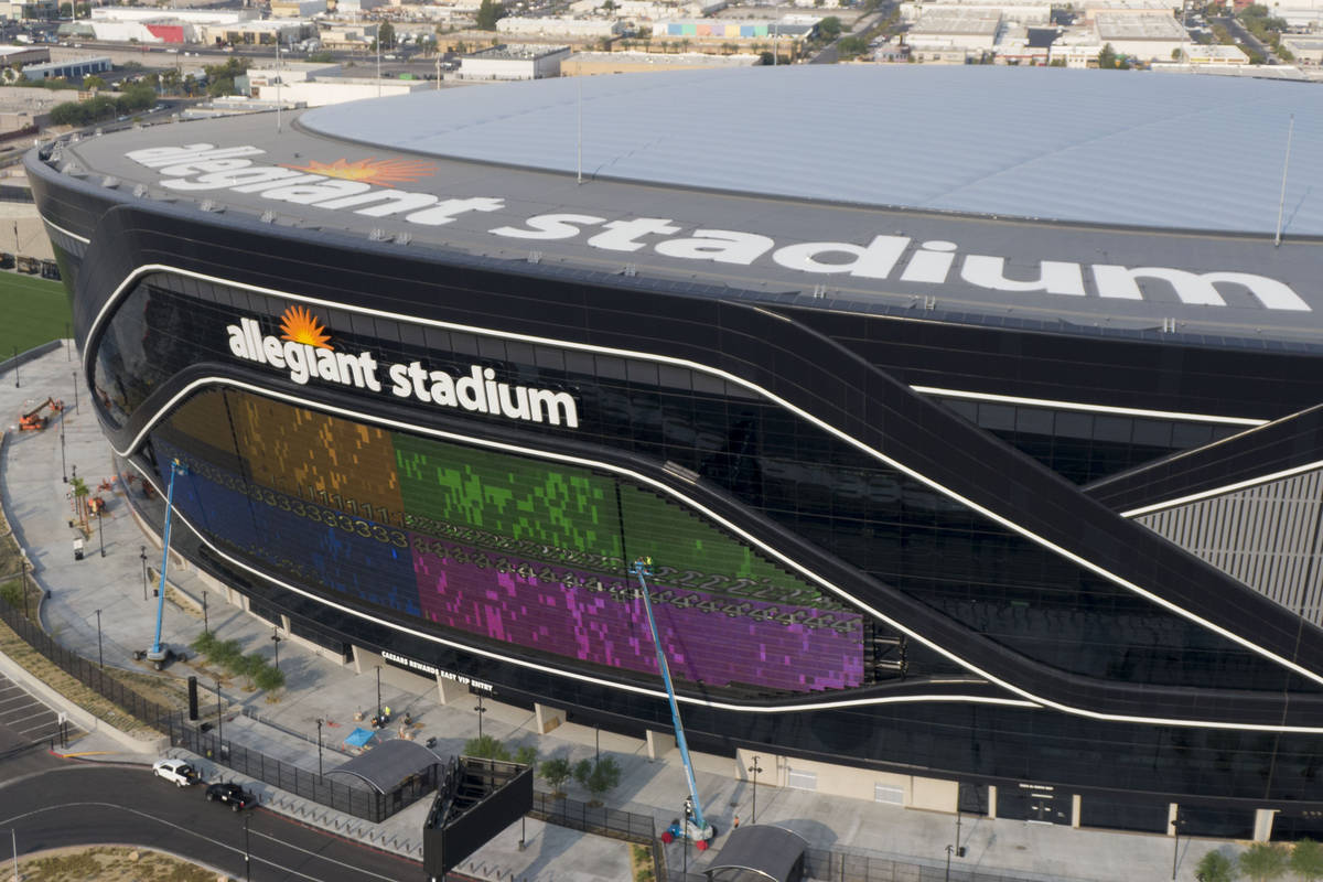 A massive 27,600 square foot video board lights up with color on the Interstate 15 facing porti ...