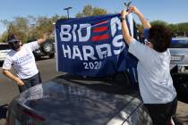 Gwen Leonard, left, and her wife Mercy Leonard, put up a flag in preparation for the ballot dro ...